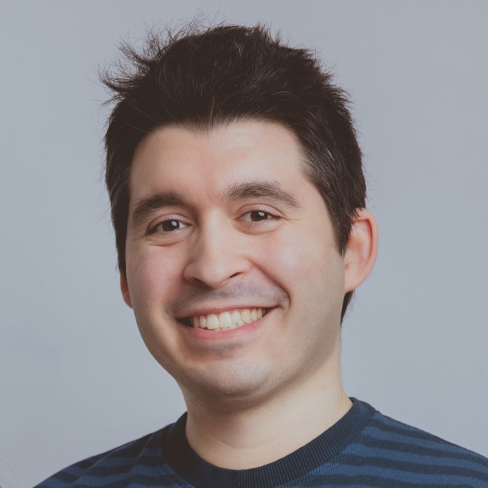 Portrait of Enrico; a man facing
      the camera, smiling